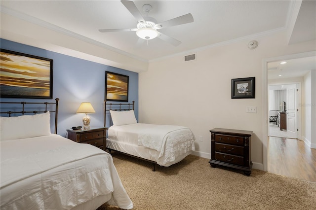 bedroom featuring ceiling fan, ornamental molding, and light hardwood / wood-style flooring