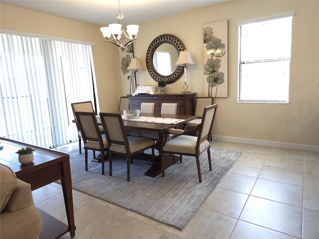 tiled dining room featuring a notable chandelier