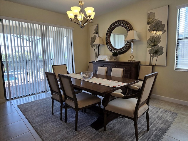 dining area with light tile patterned flooring and a chandelier