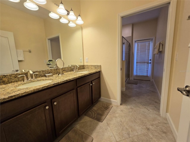 bathroom featuring tile patterned flooring, vanity, and a shower with door