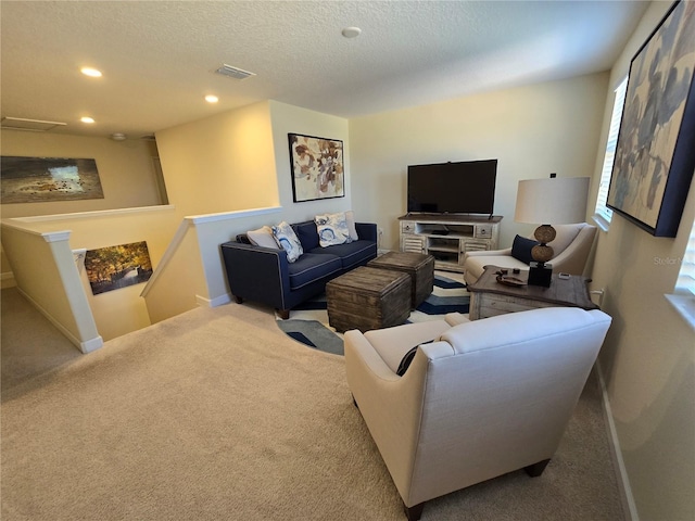 carpeted living room featuring a textured ceiling