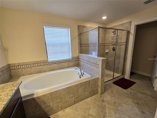 bathroom featuring tile patterned flooring, vanity, and shower with separate bathtub