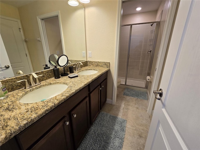 bathroom with tile patterned flooring, vanity, toilet, and walk in shower