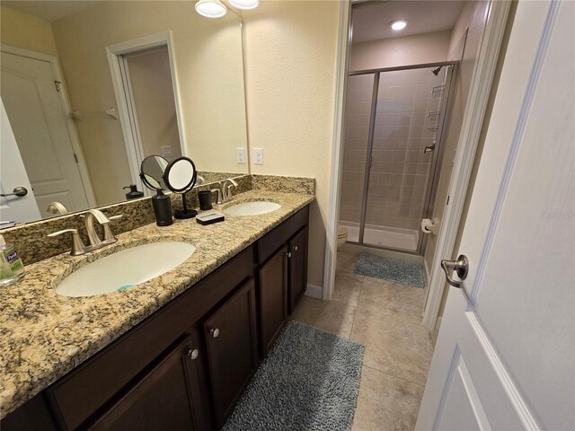 9037 Shadow Mountain St, Davenport, FL 33896 - bathroom featuring a stall shower, double vanity, and tile patterned flooring