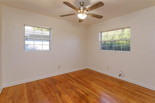 spare room featuring wood-type flooring and ceiling fan