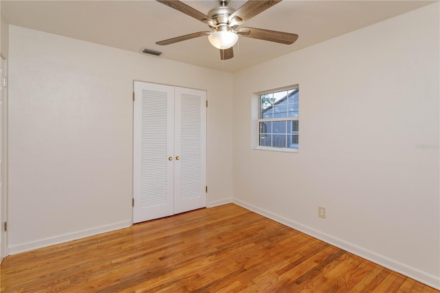 unfurnished bedroom with ceiling fan, light hardwood / wood-style floors, and a closet