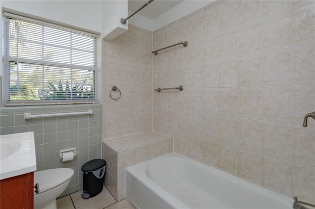 full bathroom featuring vanity, tile walls, tile patterned flooring, toilet, and tiled shower / bath