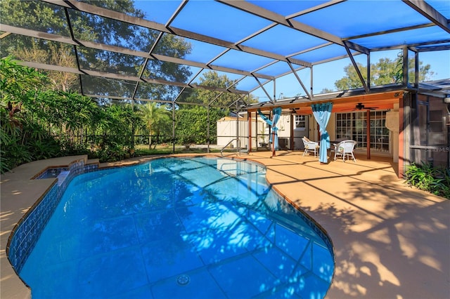 view of swimming pool featuring a patio area, ceiling fan, and a lanai