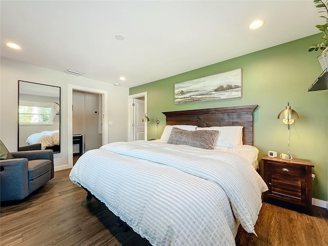 bedroom with dark hardwood / wood-style flooring