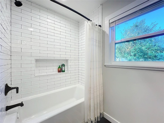 bathroom with shower / bath combination with curtain