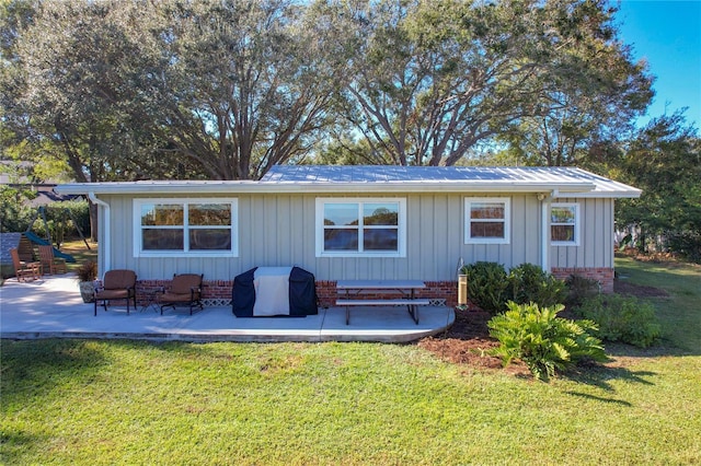 rear view of house with a patio area and a yard