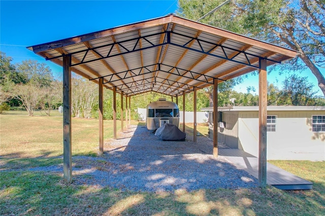 view of car parking featuring a lawn and a carport