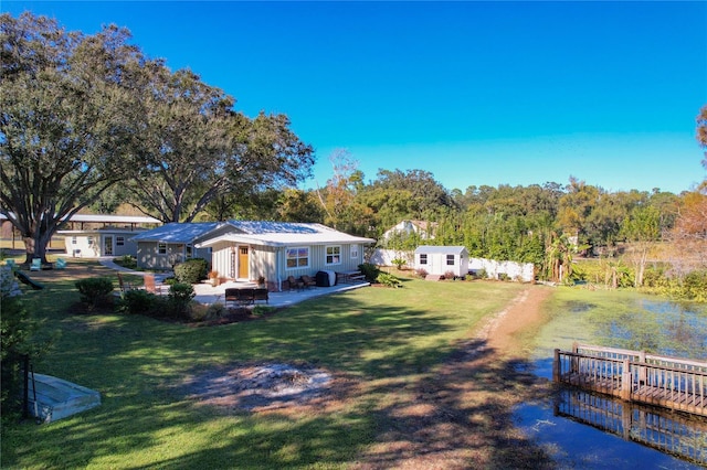view of yard featuring fence, an outbuilding, a patio, and a storage unit