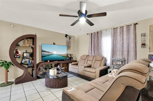 living room featuring light tile patterned floors, a textured ceiling, and ceiling fan