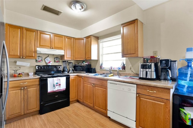 kitchen featuring dishwasher, light hardwood / wood-style flooring, black electric range oven, and sink