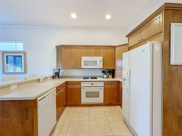 kitchen featuring white appliances, sink, ornamental molding, light tile patterned flooring, and kitchen peninsula