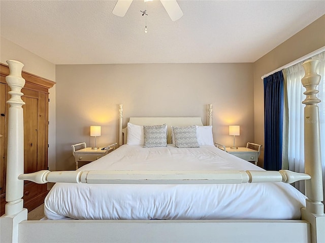 bedroom with ceiling fan and a textured ceiling