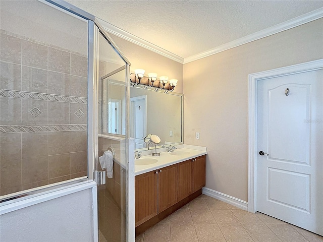 bathroom featuring vanity, tile patterned flooring, ornamental molding, a textured ceiling, and an enclosed shower