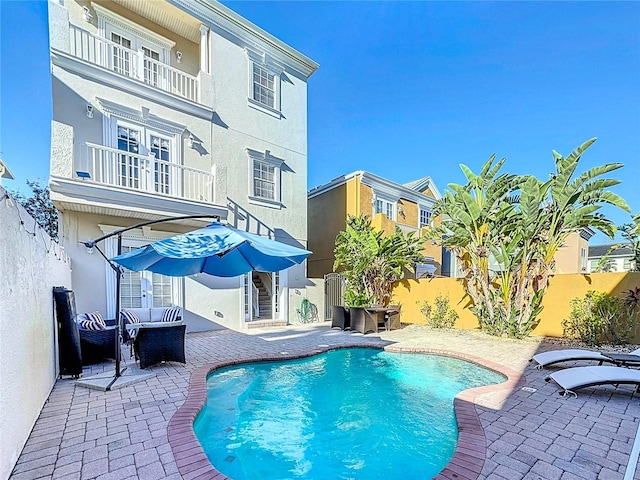 view of swimming pool with an outdoor living space and a patio