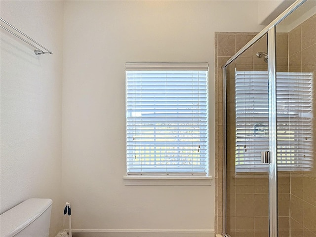 bathroom with walk in shower and toilet