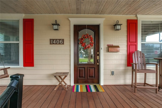 view of exterior entry featuring a porch