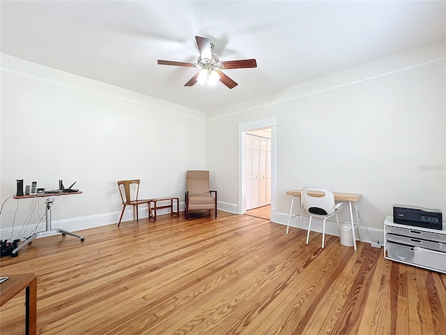 living area featuring light hardwood / wood-style flooring, ceiling fan, and ornamental molding