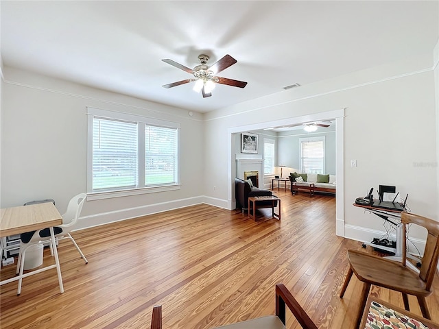 interior space with ceiling fan, crown molding, and wood-type flooring