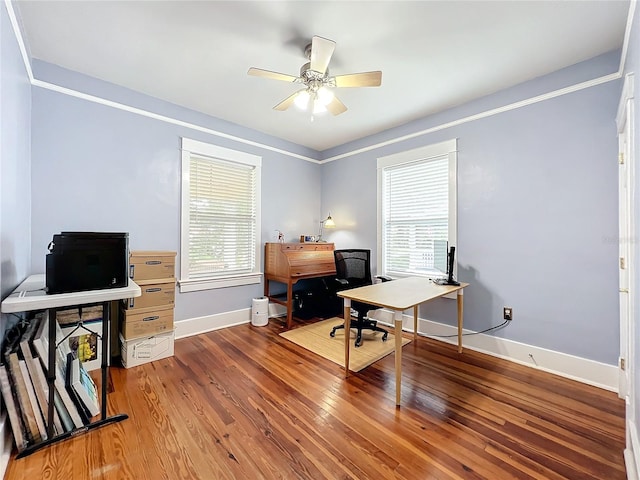 home office with ceiling fan, a healthy amount of sunlight, wood-type flooring, and ornamental molding