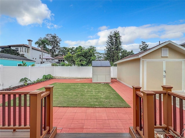 view of yard featuring a patio area and a storage shed