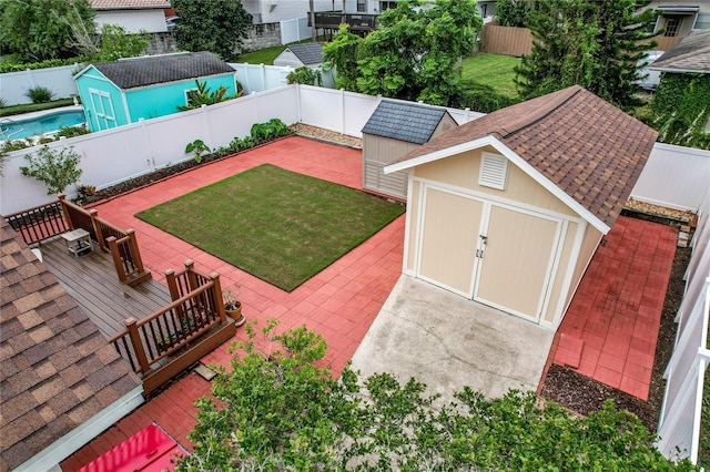 view of yard featuring a patio and a shed