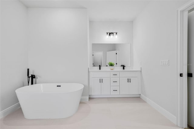 bathroom with a washtub and vanity