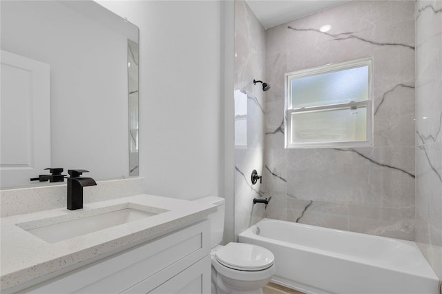 full bathroom with toilet, vanity, and tiled shower / bath