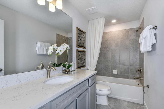 full bathroom featuring vanity, tile patterned floors, toilet, a textured ceiling, and shower / tub combo