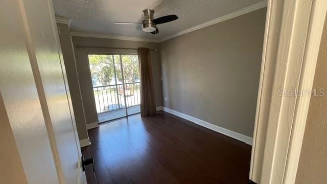 unfurnished room featuring ceiling fan, dark wood-type flooring, and ornamental molding