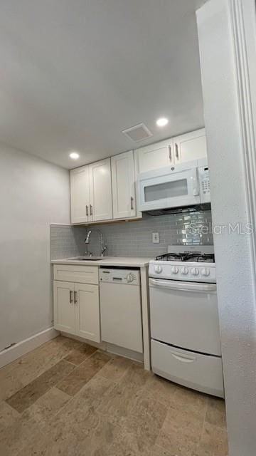 kitchen featuring backsplash, white cabinetry, white appliances, and sink