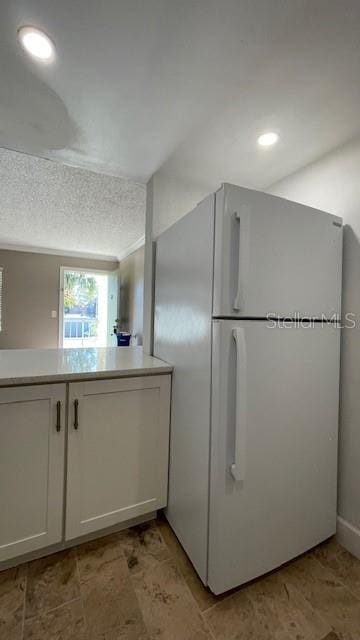 kitchen with white cabinets and white refrigerator