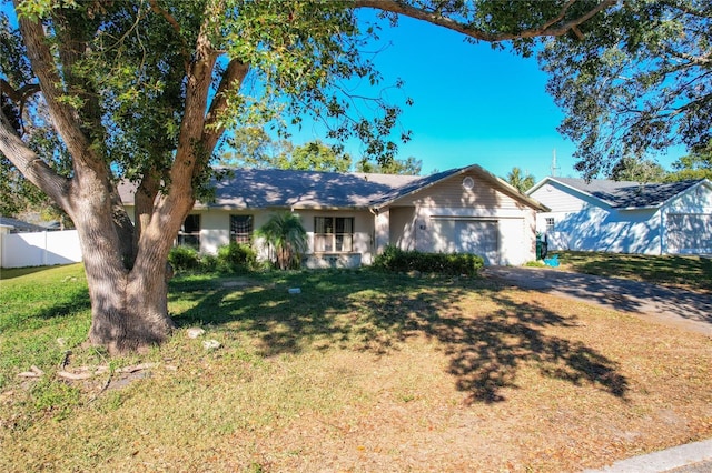 single story home featuring a garage and a front lawn