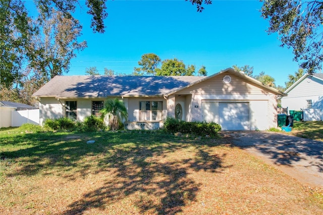 ranch-style house with a garage and a front lawn