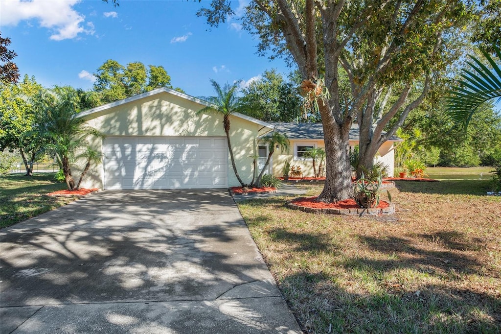 ranch-style house with a front yard and a garage