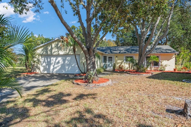 ranch-style house with a front yard and a garage