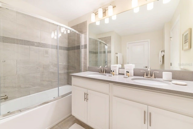 bathroom with vanity and bath / shower combo with glass door