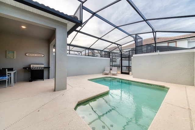 view of swimming pool with a patio, a lanai, and a grill