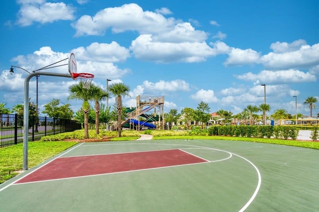 view of basketball court with a playground