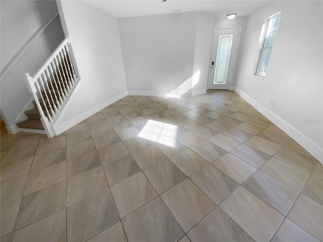 spare room featuring light tile patterned floors