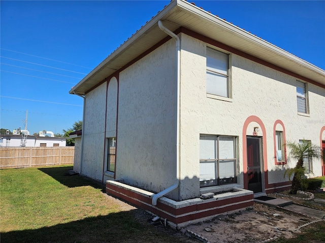 rear view of house with a yard