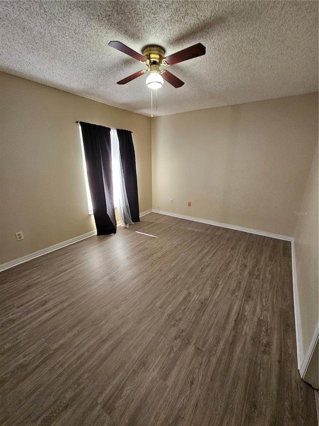 unfurnished room featuring ceiling fan, dark hardwood / wood-style flooring, and a textured ceiling