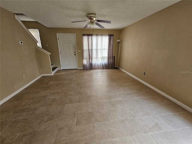 foyer featuring a textured ceiling and ceiling fan