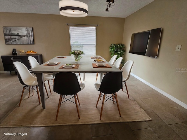 dining room featuring a textured ceiling