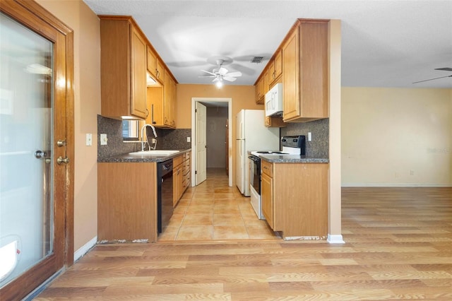 kitchen with backsplash, light hardwood / wood-style flooring, white appliances, and sink