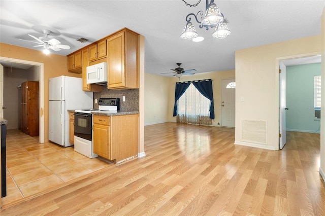 kitchen with decorative backsplash, white appliances, and light hardwood / wood-style floors